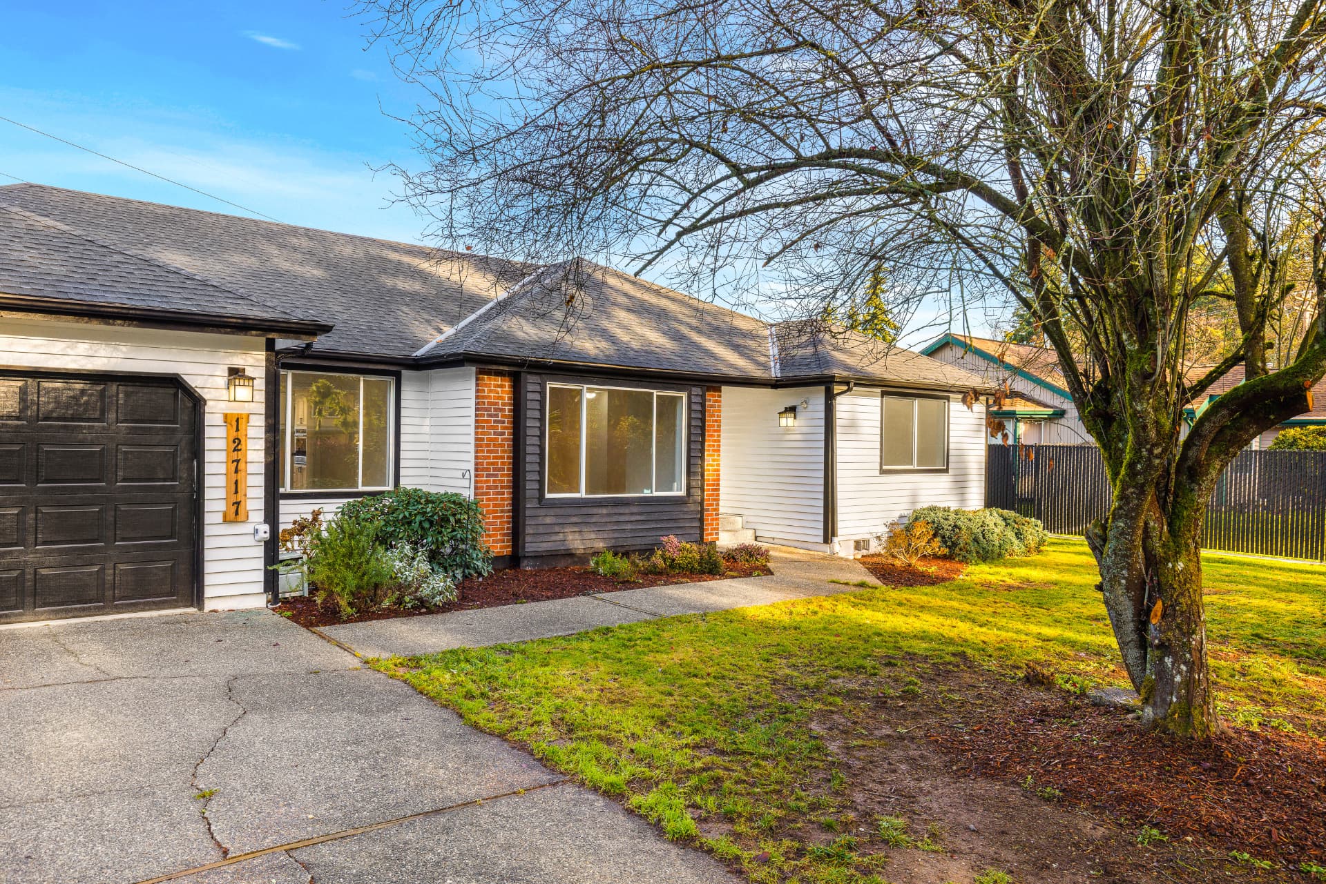 Single-story home with a completed shingle roof and new gutters