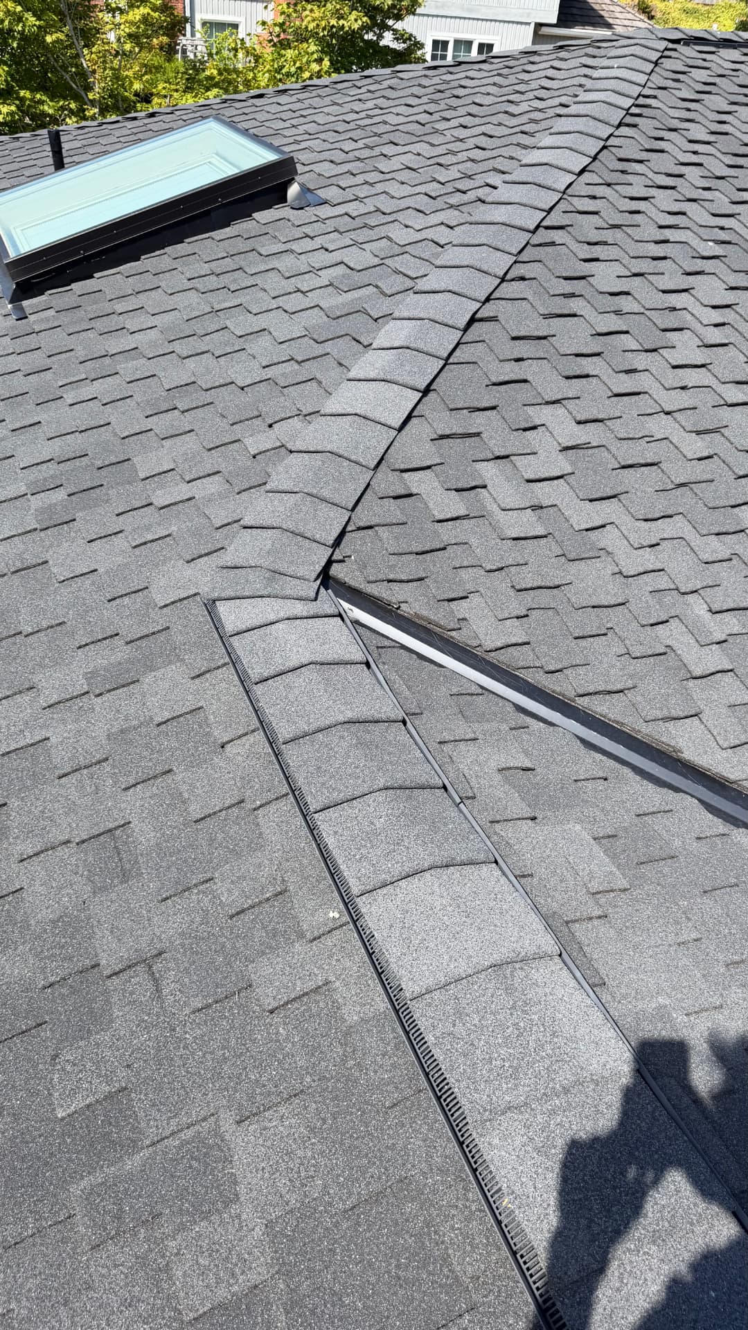 Ridge vent and hip detail on a completed GripGo Roofing shingle replacement